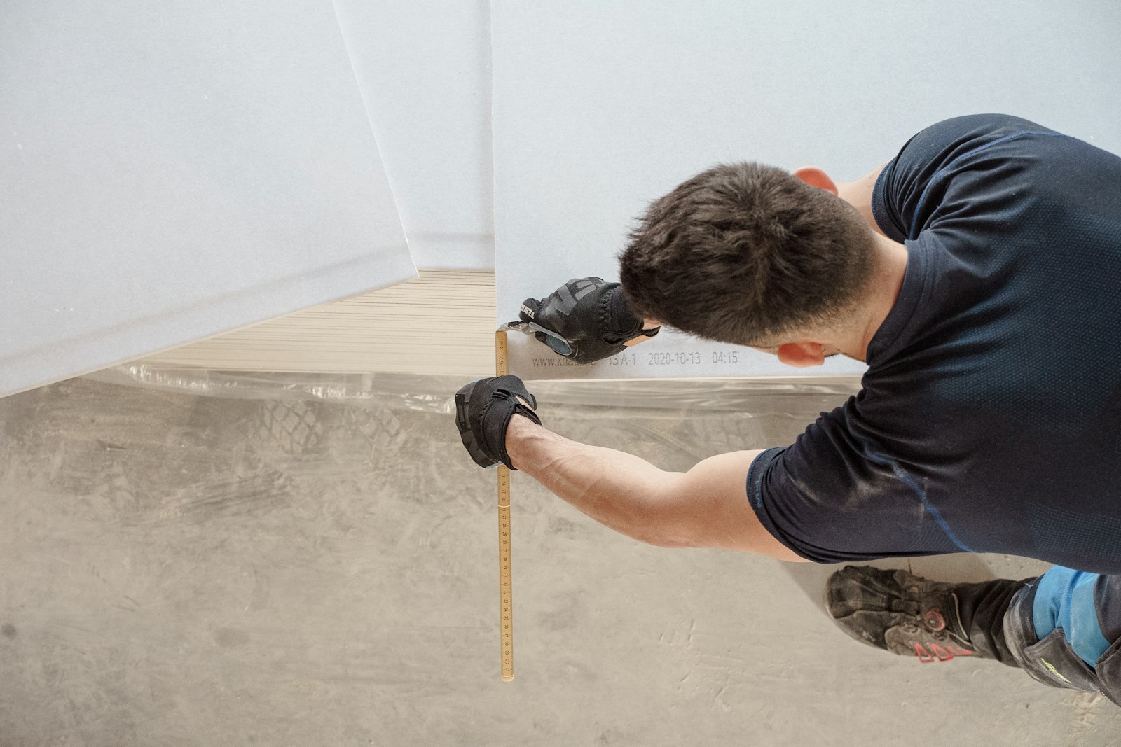Carpenter measuring a timber board on site